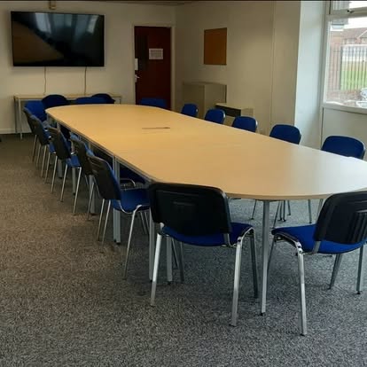 Conference room laid out with rows of chairs for a members meeting