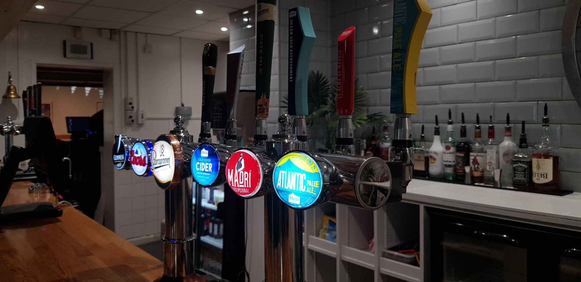 The Ruston's Sports Bar — illuminated beer taps including Guinness, Madrí and Staropramen